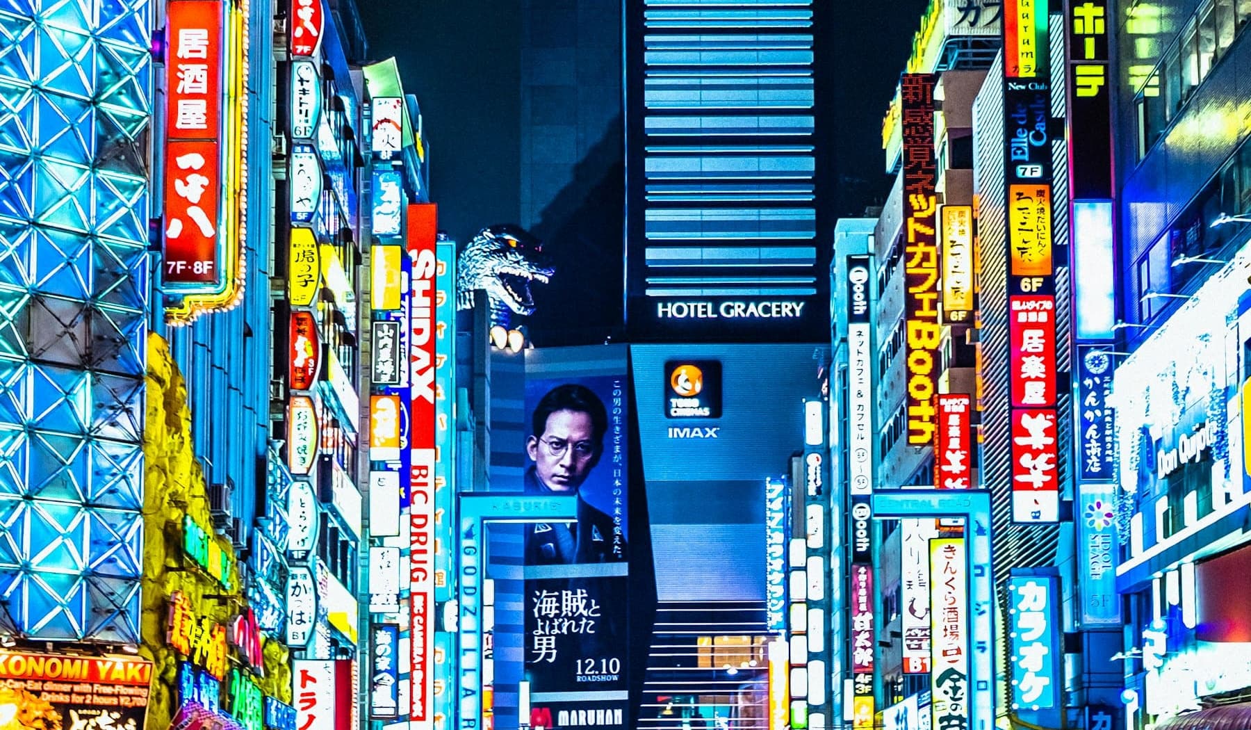 Neon signage along Kabukichō’s Central Road at night, with the Godzilla head above Hotel Gracery